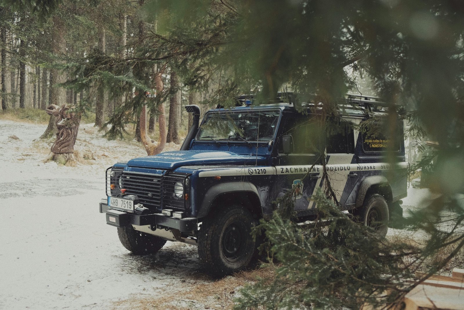 blue and black jeep wrangler on dirt road during daytime