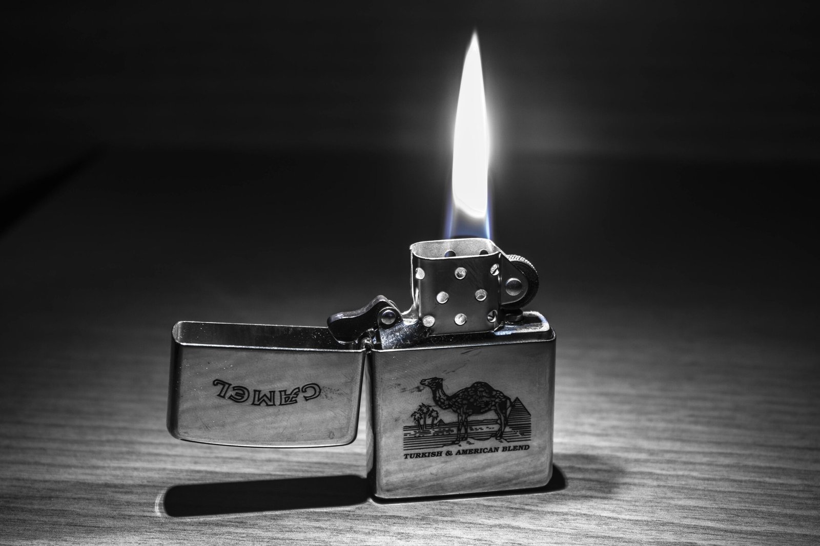 Close-up of a lit Zippo lighter with a clear flame. Perfect for themes of heat and light.